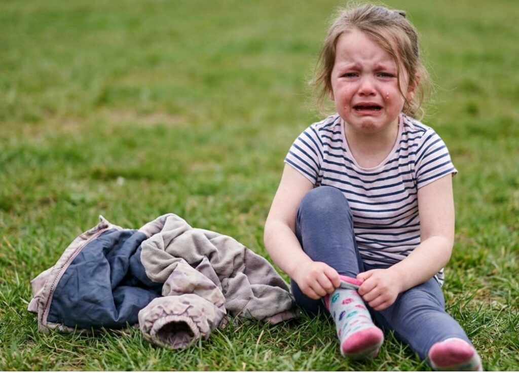 child wearing clothes that make her cry